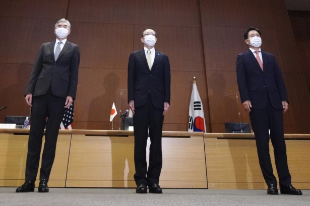 Japanese Foreign Ministry's Director-General of the Asian and Oceanian Affairs Bureau Takehiro Funakoshi (C), U.S. Special Representative for North Korea, Sung Kim (L), and South Korea's Special Representative for Korean Peninsula Peace and Security Affairs Noh Kyu-duk pose for photographers during their trilateral meeting on North Korean issue at the Foreign Ministry in Tokyo on Sept. 14, 2021. (Eugene Hoshiko/AP Photo)