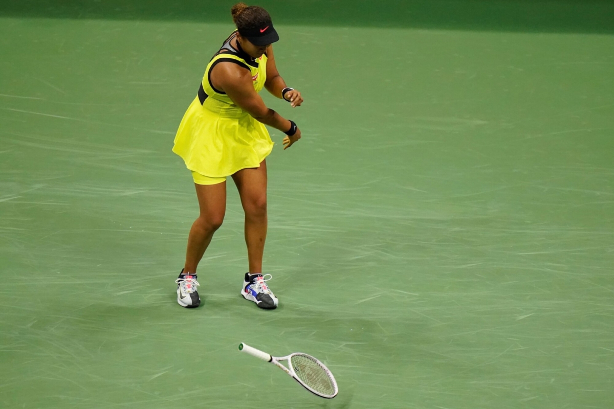 Naomi Osaka, of Japan, throws her racket down during a match against Leylah Fernandez, of Canada, at the third round of the U.S. Open tennis championships, N.Y., on Sept. 3, 2021. (Frank Franklin II/AP Photo)