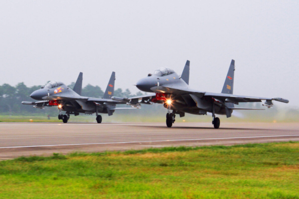 In this undated file photo by China's Xinhua News Agency, two Chinese SU-30 fighter jets take off from an unspecified location to fly a patrol over the South China Sea. (Jin Danhua/Xinhua via AP, File)
