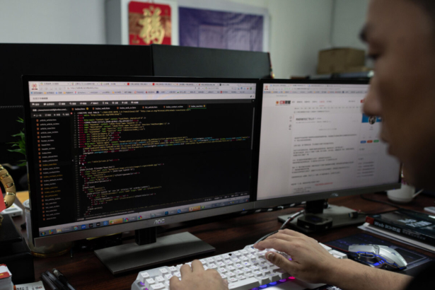 Prince, a member of the hacking group Red Hacker Alliance who declined to give his real name, uses his computer at their office in Dongguan, Guangdong Province, China, on Aug. 4, 2020. (Nicolas Asfouri/AFP via Getty Images)
