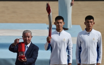 Olympic Torch Handed to Beijing Amid Boycott Calls