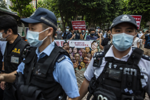 Pro-democracy activists (C) from the League of Social Democrats protest in the Wan Chai district of Hong Kong on Oct. 1, 2021, as China celebrates its National Day. (Isaac Lawrence/AFP via Getty Images)
