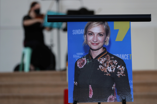A musician plays a violin behind a photograph of cinematographer Halyna Hutchins during a vigil in her honor in Albuquerque, N.M., on Oct. 23, 2021. (Andres Leighton/AP Photo)