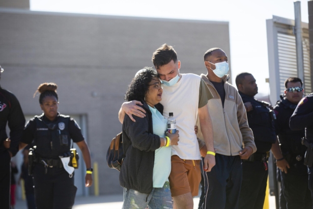 People exit the Harris County Institute of Forensic Sciences area mourning the death of a Harris County Pct. 4 deputy in north Houston, Texas, on Oct. 16, 2021. (Marie D. De Jesús/Houston Chronicle via AP)
