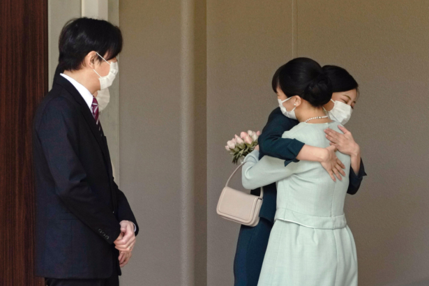 Japan's Princess Mako, right, hugs her sister Princess Kako, watched by her parents Crown Prince Akishino and Crown Princess Kiko, before leaving her home in Akasaka Estate in Tokyo on Oct. 26, 2021. (Koki Sengoku/Kyodo News via AP)