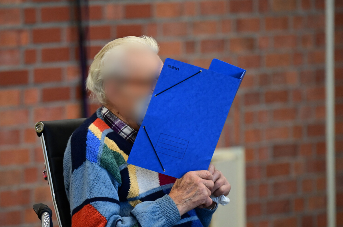 Defendant Josef S. hides his face behind a folder as he arrives for his trial in Brandenburg an der Havel, northeastern Germany, on Oct. 7, 2021. (Tobias Schwarz/AFP via Getty Images)