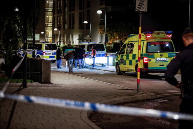 Ambulance and police stand at the scene where Swedish rapper Einar was shot to death, in Hammarby Sjostad district in Stockholm, early on Oct. 22, 2021. (Christine Olsson/TT via AP)