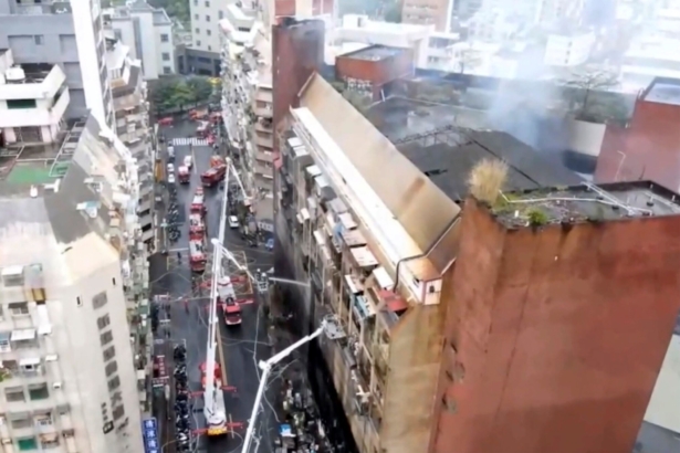 In this image taken from video by Taiwan's EBC, firefighters shoot water into a building that caught fire in Kaohsiung, in southern Taiwan on Oct. 14, 2021. (EBC via AP )