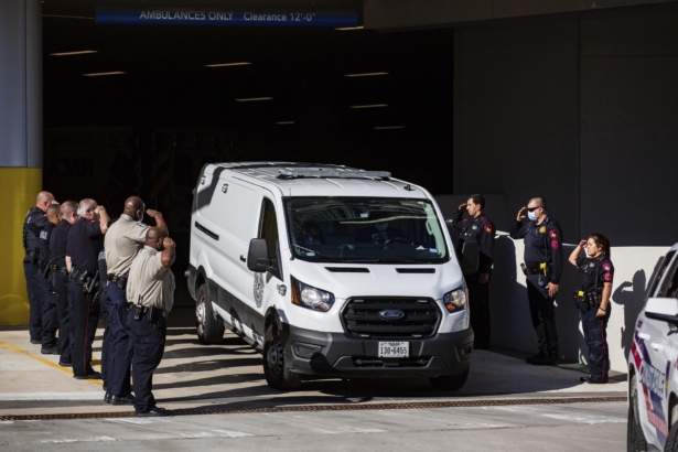 Harris County Medical Examiner exits the Memorial Hermann Hospital in a van transporting a Harris County Pct. 4 deputy who was shot and killed to the Harris County Institute of Forensic Sciences in Houston, Texas, on Oct. 16, 2021. (Marie D. De Jesús/Houston Chronicle via AP)