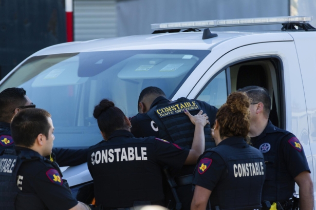 Harris County Pct. 4 deputies provide support to each other at the Harris County Institute of Forensic Sciences after the body of a deputy who was shot and killed was transported to the building from Memorial Hermann Hospital in Houston, Texas, on Oct. 16, 2021. (Marie D. De Jesús/Houston Chronicle via AP)