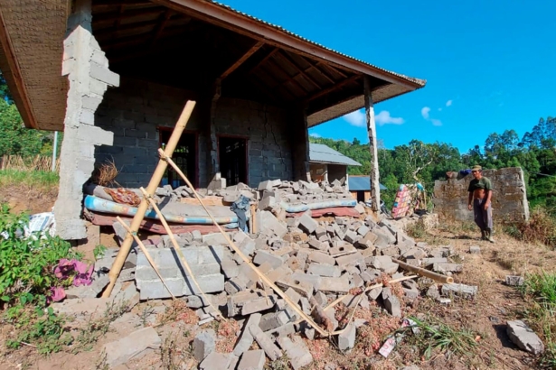 A man stands near his house damaged by an earthquake in Karangasem on the island of Bali, Indonesia on Oct. 16, 2021. (Andi Husein/AP Photo)