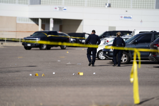 Evidence markers dot the parking lot of Hinkley High School in Aurora, Colo., on Nov. 19, 2021. (Philip B. Poston/Sentinel Colorado via AP)