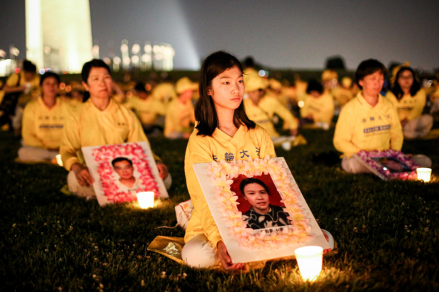Falun Gong practitioners take part in a candlelight vigil remembering victims of the 22-year-long persecution in China at the Washington Monument on July 16, 2021. (Samira Bouaou/The Epoch Times).