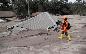 Indonesian Rescuers Dig Through Volcanic Ash After 14 Die