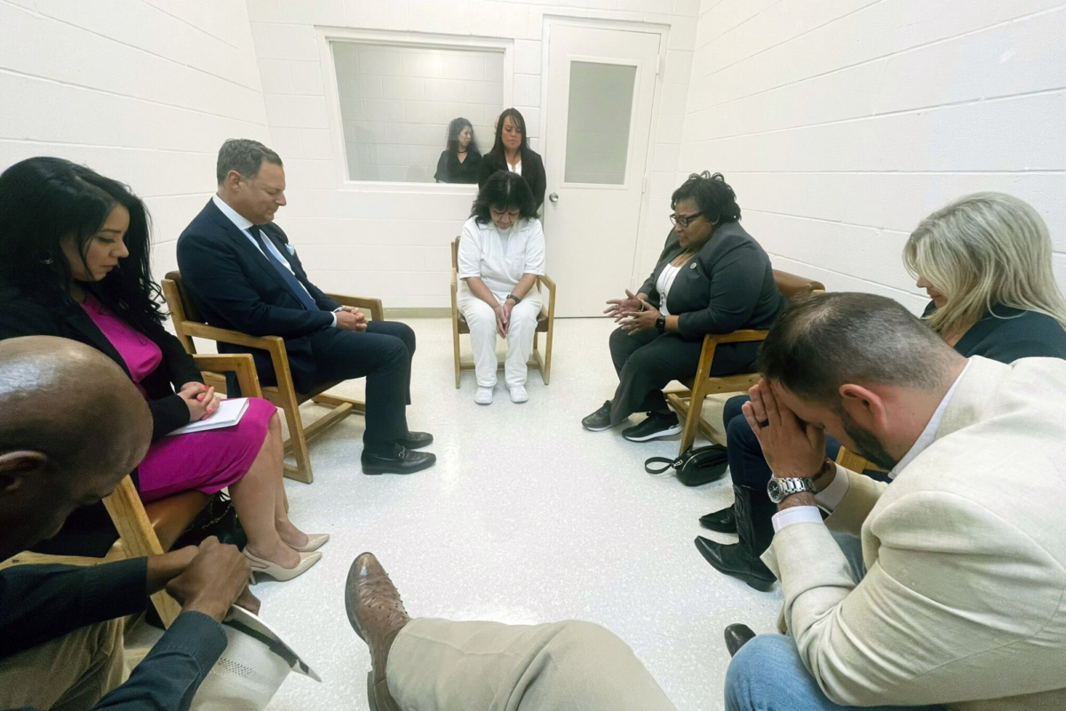 Melissa Lucio (C) leads a group of seven Texas lawmakers in prayer in a room at the Mountain View Unit in Gatesville, Texas, in April 6, 2022. (Texas state Rep. Jeff Leach via AP)