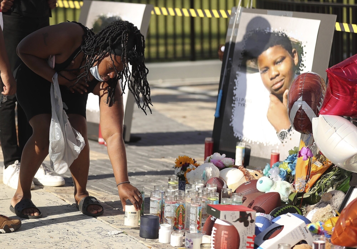 Family members and friends of Tyre Sampson leave items during a vigil in front of the Orlando Free Fall drop tower in ICON Park in Orlando, Fla., on March 28, 2022. (Stephen M. Dowell/Orlando Sentinel via AP)