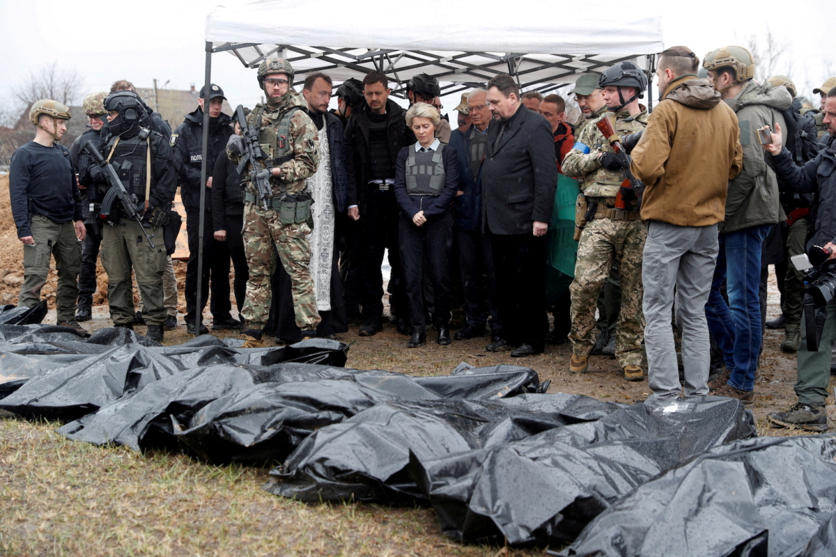 European Commission President Ursula von der Leyen, High Representative of the European Union for Foreign Affairs and Security Policy Josep Borrell, Slovakia's Prime Minister Eduard Heger and Ukraine's Prime Minister Denys Shmyhal stand next to a mass grave as they visit the town of Bucha, outside of Kyiv, Ukraine, on April 8, 2022. (Valentyn Ogirenko/File Photo via Reuters)