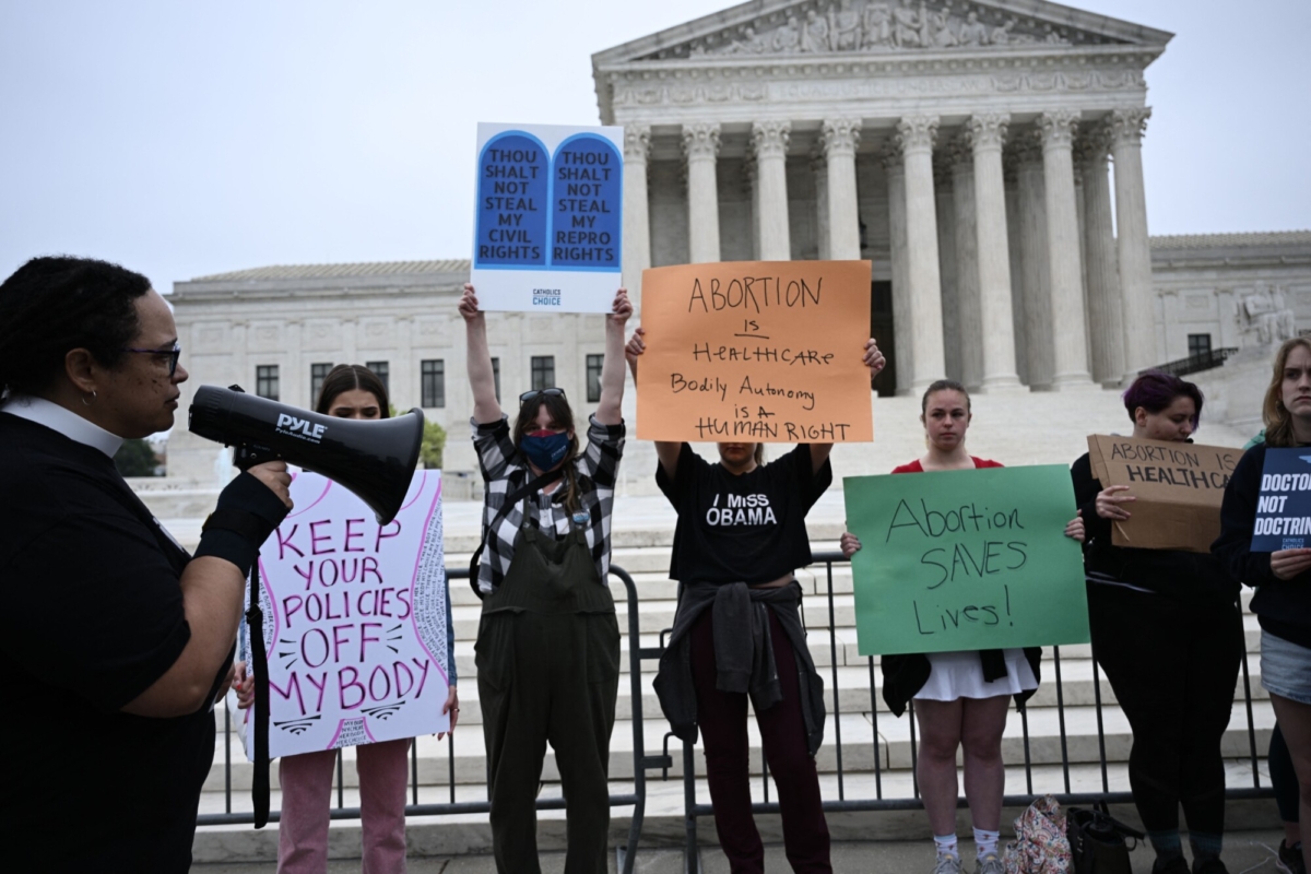 Pro-abortion demonstrators hold signs in front of the Supreme Court in Washington, on May 3, 2022. (Brendan Smialowski/AFP via Getty Images)