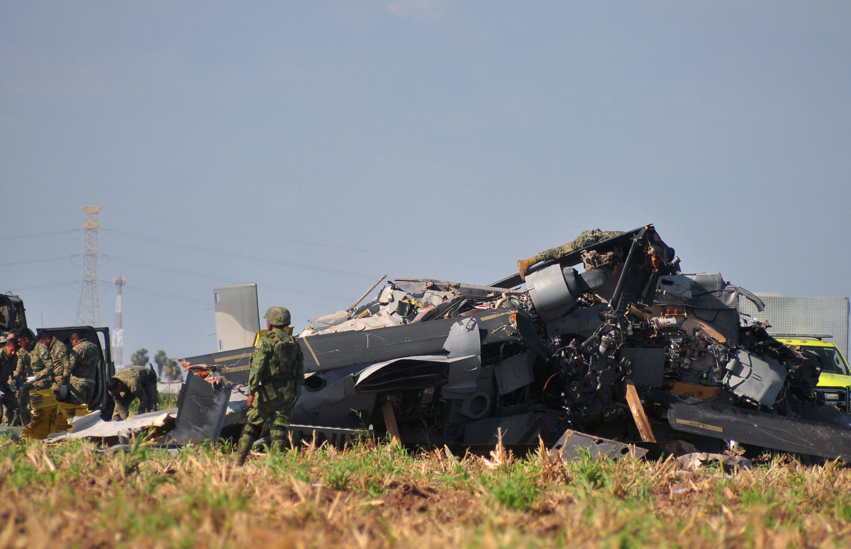 Soldiers of the Mexican Army inspect the wreckage of a Navy helicopter that crashed near the airport of Los Mochis, Sinaloa State, Mexico, on July 15, 2022. (Jose Mendoza/AFP via Getty Images)