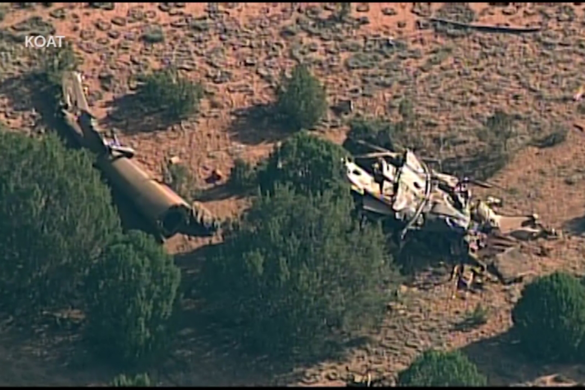 This image from video shows the scene where four people were killed in a crash of a Bernalillo County Sheriff's Office helicopter that was headed back to Albuquerque after assisting firefighters near Las Vegas, N.M., on July 17, 2022. (KOAT via AP)