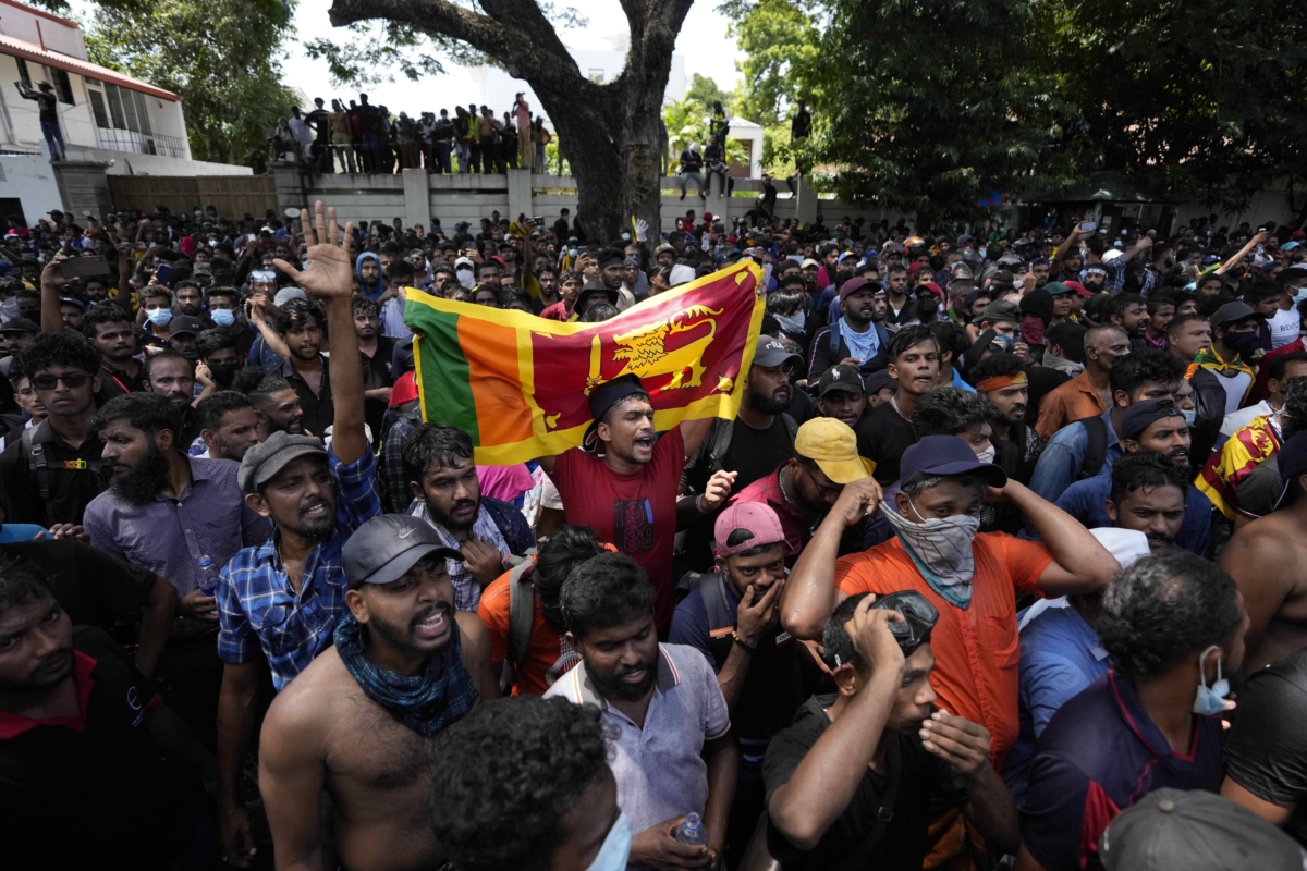 Sri Lankan protesters storm the compound of Prime Minister Ranil Wickremesinghe's office, demanding he resign after President Gotabaya Rajapaksa fled the country amid an economic crisis in Colombo, Sri Lanka, on July 13, 2022. (Eranga Jayawardena/AP Photo)