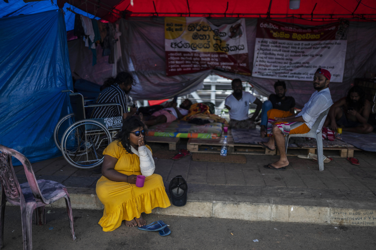 Protesters sit at their protest site in the morning in Colombo, Sri Lanka, on July 21, 2022. (Rafiq Maqbool/AP Photo)