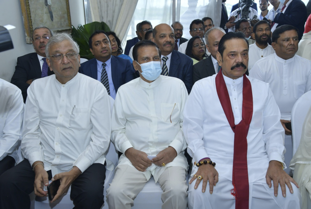 Lawmaker Lakshman Kiriella (L), former president Maithripala Sirisena (C), and former prime minister Mahinda Rajapaksa (R) attend the swearing in ceremony of Sri Lanka's newly elected president Ranil Wickremesinghe, in Colombo, Sri Lanka, on July 21, 2022. (Sri Lankan President's Office via AP)