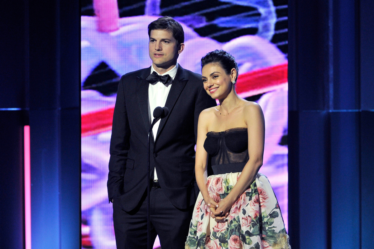 Actors Ashton Kutcher (L) and Mila Kunis speak onstage during the 2018 Breakthrough Prize at NASA Ames Research Center in Mountain View, Calif. on Dec. 3, 2017. (Steve Jennings/Getty Images)