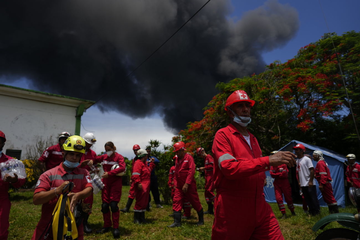 Members of the Cuban Red Cross prepare to be transported to the Matanzas Supertanker Base, where firefighters work to quell a blaze which began during a thunderstorm the night before, in Matazanas, Cuba, on Aug. 6, 2022. (Ramon Espinosa/AP Photo)
