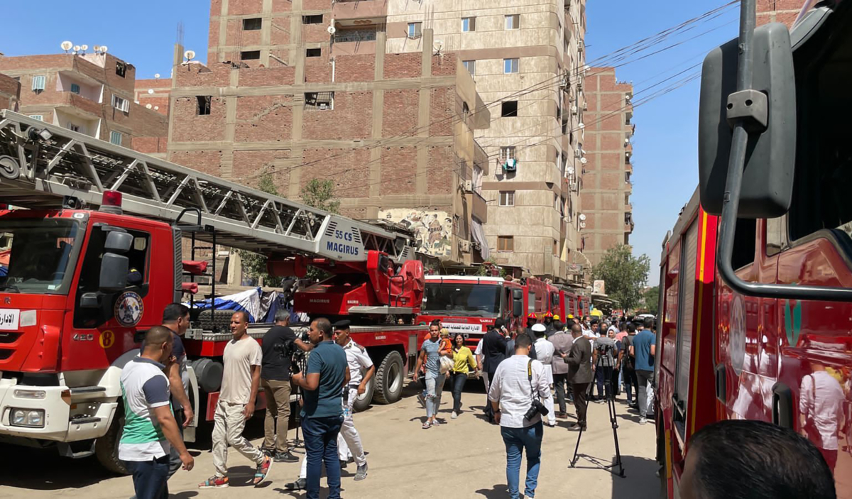 Emergency personnel work at the site of a fire at the Abu Sefein church in the neighborhood of Imbaba, Cairo, Egypt, on Aug. 14, 2022. (Mohamed Salah/AP Photo)
