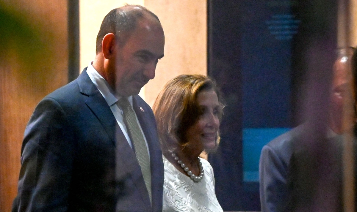 U.S. House Speaker Nancy Pelosi (2nd L) leaves the Shangri-La Hotel after a reception organized by the American Chamber of Commerce in Singapore on Aug. 1, 2022. (Roslan Rahman/AFP via Getty Images)