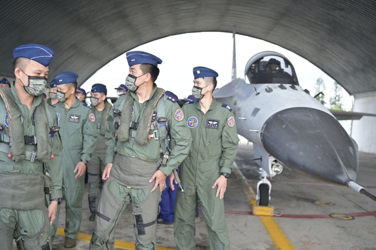 Taiwanese pilots walk pass an Indigenous Defense Fighter (IDF) at an air force base while Taiwan President Tsai Ing-wen (not pictured) inspects military troops on Penghu islands, Taiwan, on Aug. 30, 2022. (Sam Yeh/AFP via Getty Images)
