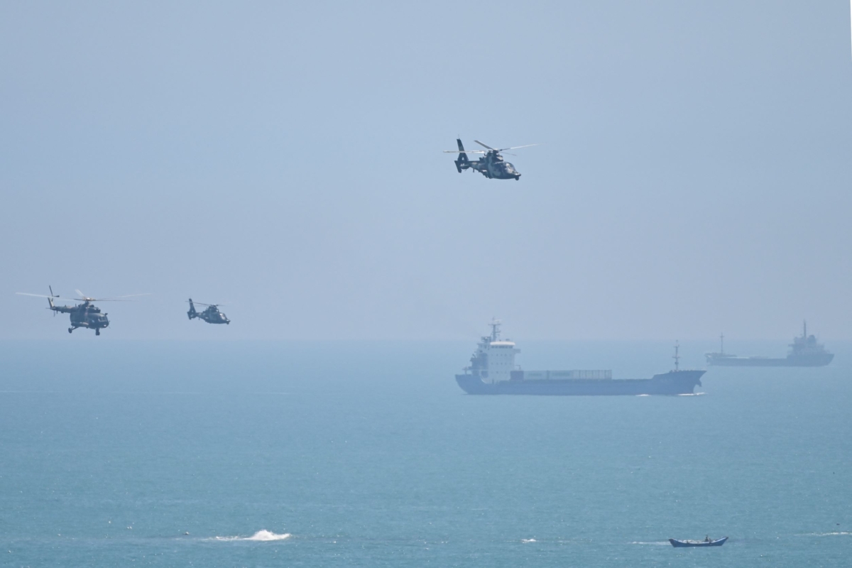 Chinese military helicopters fly past Pingtan island, one of mainland China's closest point from Taiwan, in Fujian Province on Aug. 4, 2022. (Hector Retamal/AFP via Getty Images)