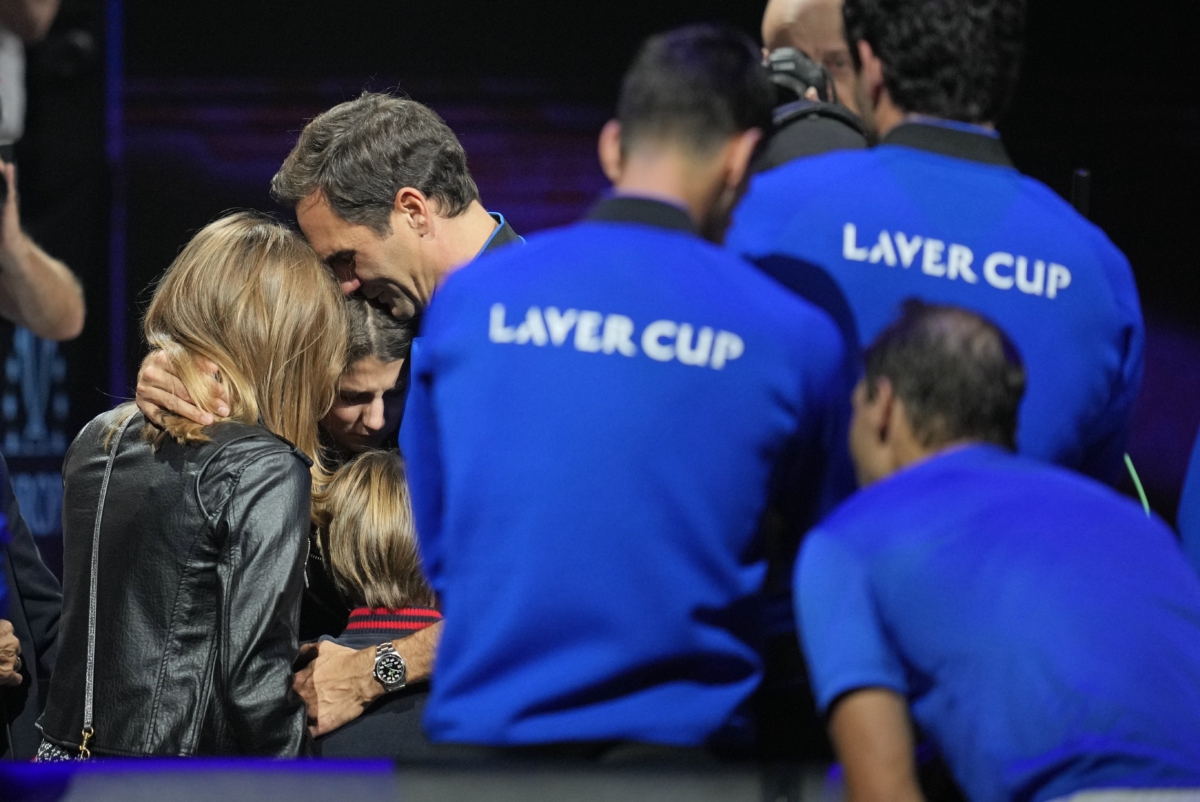 An emotional Roger Federer of Team Europe embraces his wife Mirka and their children after playing with Rafael Nadal in a Laver Cup doubles match against Team World's Jack Sock and Frances Tiafoe at the O2 arena in London on Sept. 23, 2022. (Kin Cheung/AP Photo)
