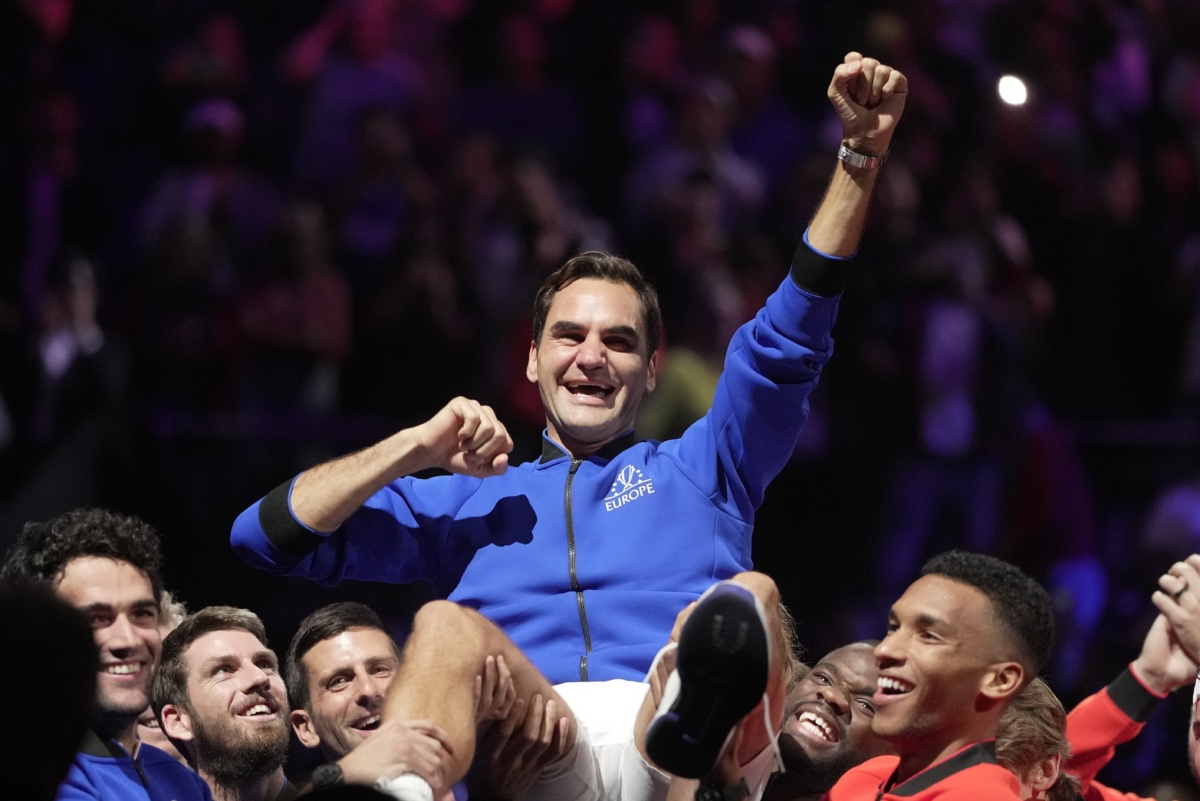 Team Europe's Roger Federer is lifted by fellow players after playing with Rafael Nadal in a Laver Cup doubles match against Team World's Jack Sock and Frances Tiafoe at the O2 arena in London on Sept. 23, 2022. (Kin Cheung/AP Photo)