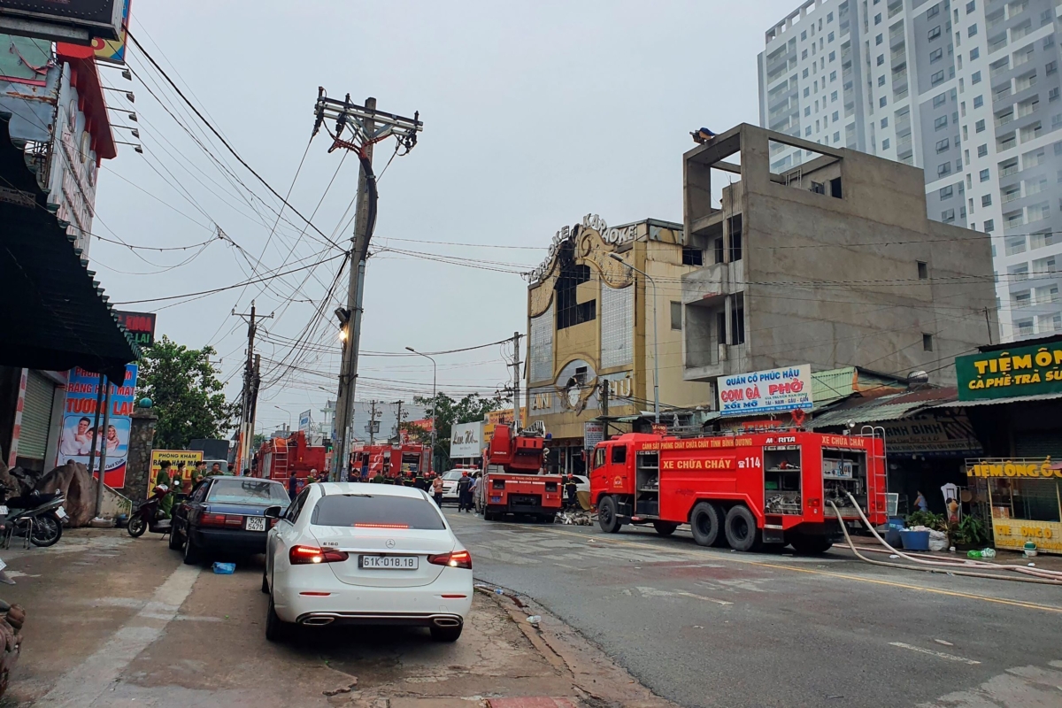 Fire department trucks line outside a karaoke parlor following a fire in Thuan An city, southern Vietnam, on Sept. 7, 2022. (Duong Trei Tuong/VNA via AP)