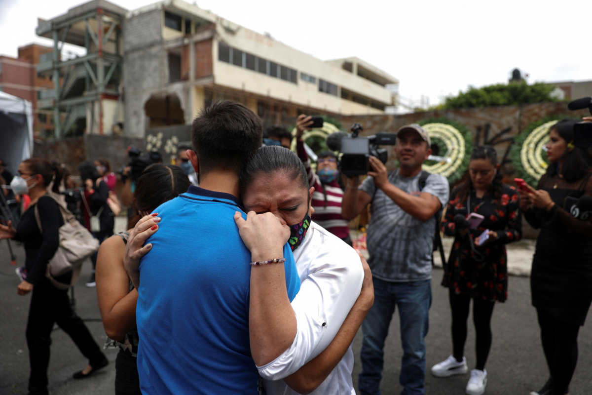 People attending an event to honor the children who died in the Enrique Rebsamen school during an earthquake in 2017, embrace as another earthquake is felt in Mexico City on Sept. 19, 2022. (Luis Cortes/Reuters)