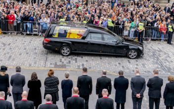 Thousands Line Streets as Queen’s Elizabeth II’s Coffin Embarks Journey to Final Resting Place