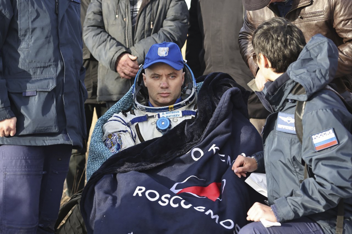 Russian cosmonaut Denis Matveyev sits in the chair shortly after the landing of the Russian Soyuz MS-21 space capsule southeast of the Kazakh town of Zhezkazgan, Kazakhstan, on Sept. 29, 2022. (Pavel Kassin, Roscosmos State Space Corporation via AP)