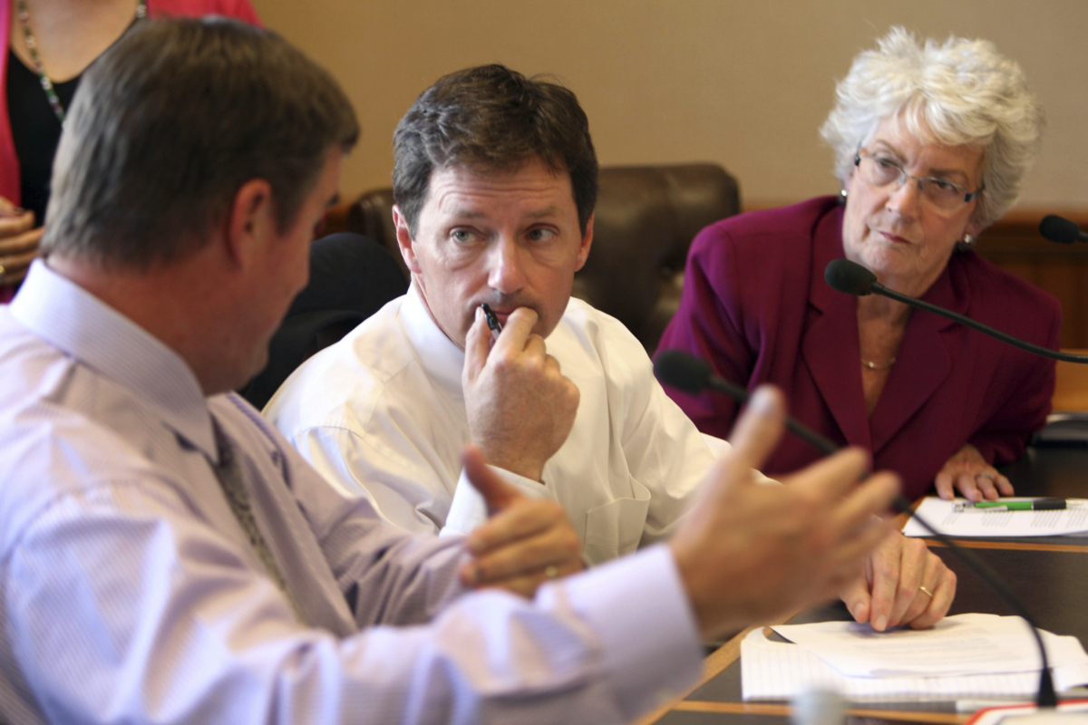 State Rep. Tom Sherman (D-Rye) (C) and state Sen. Nancy Stiles (R-Hampton) listen to state Sen. Andy Sanborn in a meeting in Concord, N.H., on Oct. 2, 2013. (Jim Cole/AP Photo)