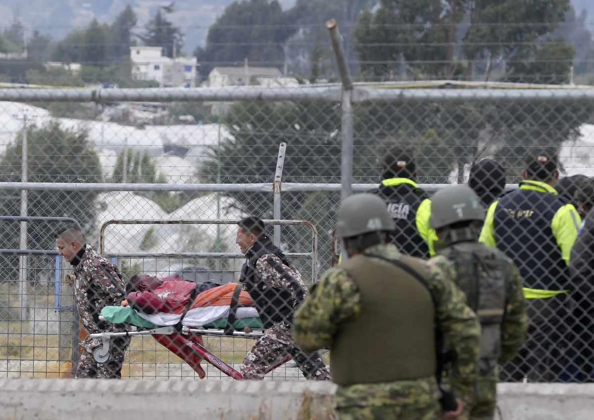 An injured inmate is evacuated in a gurney after a deadly prison riot in Latacunga, Ecuador, on Oct. 4, 2022. (Dolores Ochoa/AP Photo)