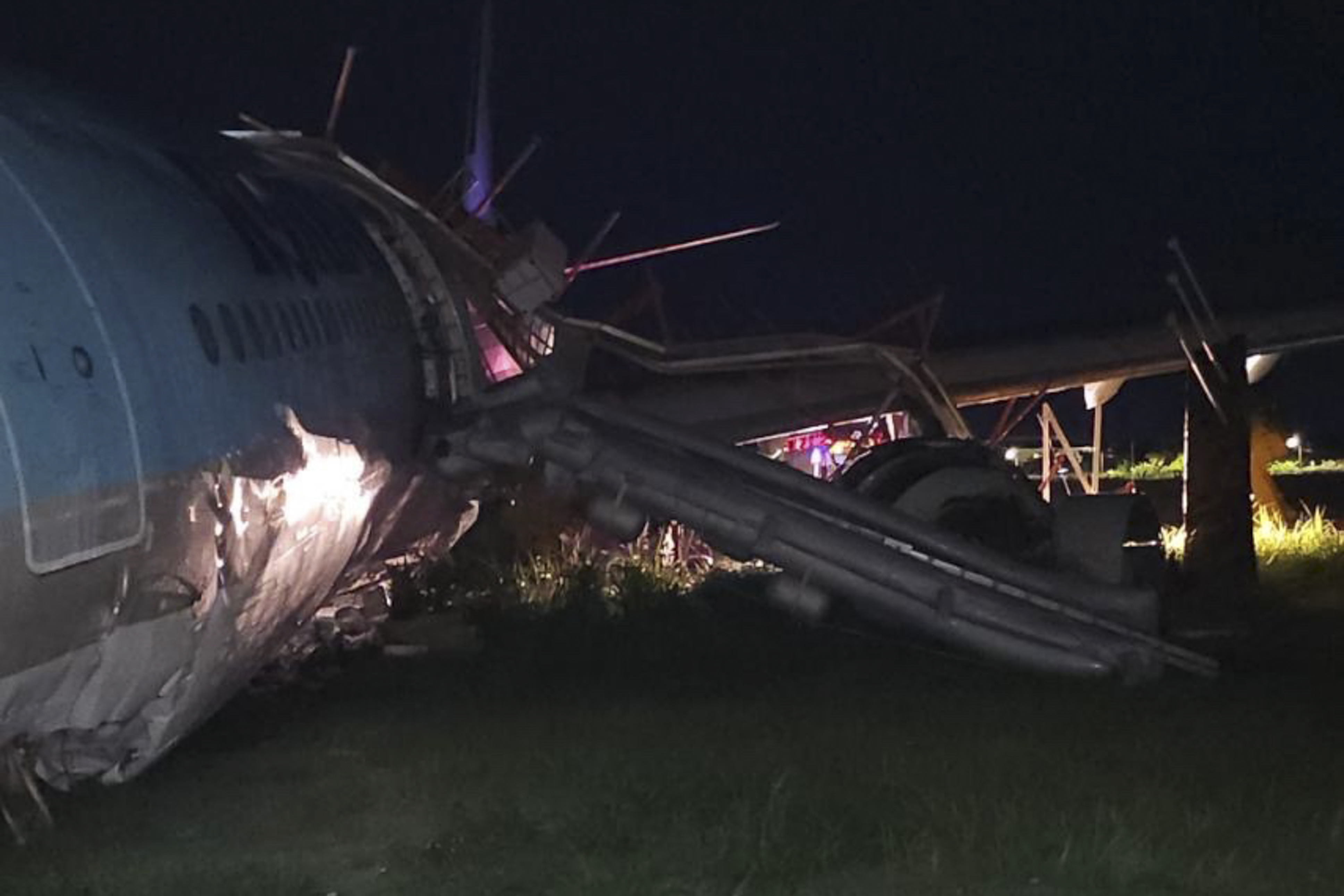 In this photo provided by the Civil Aviation Authority of the Philippines, a damaged portion of the Korean Air Lines Co. plane lies after it overshot the runway at the Mactan Cebu International Airport in Cebu, central Philippines, on Monday, Oct. 24, 2022. (Civil Aviation Authority of the Philippines via AP)