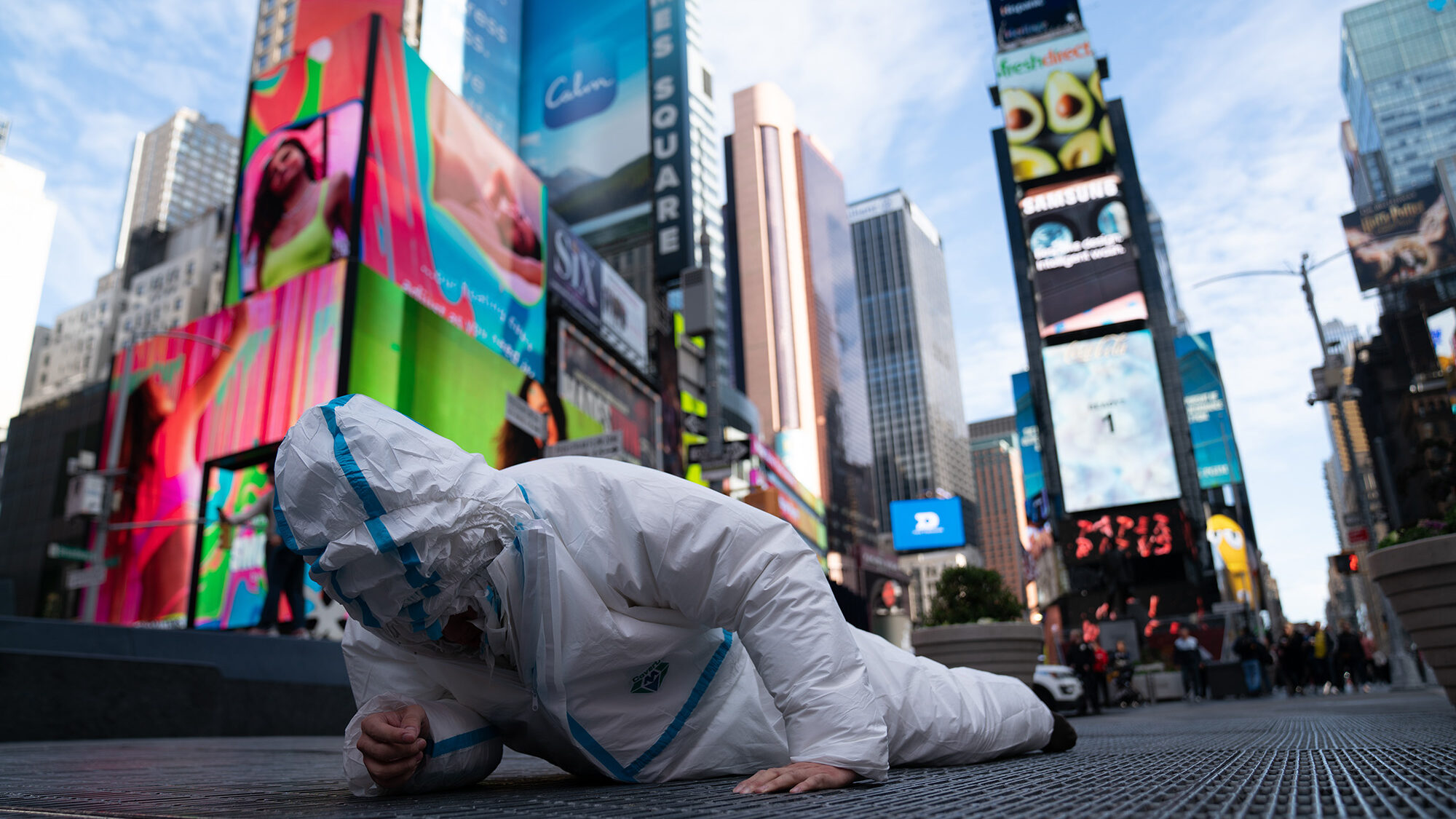 Chinese Artist Speaks Out Against Zero-COVID Policy by Wearing 27 Hazmat Suits in Times Square