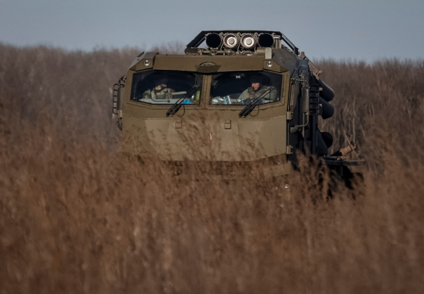 Ukrainian servicemen prepare fire with a Bureviy multiple launch rocket system at a position in Donetsk region