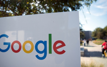 A man rides a bike passed a Google sign and logo at the Googleplex in Mountain View, Calif. on Nov. 4, 2016. (Josh Edelson/AFP via Getty Images)