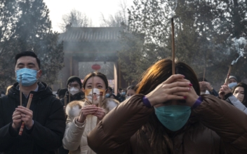 Chinese Pray for Health as COVID-19 Death Toll Rises