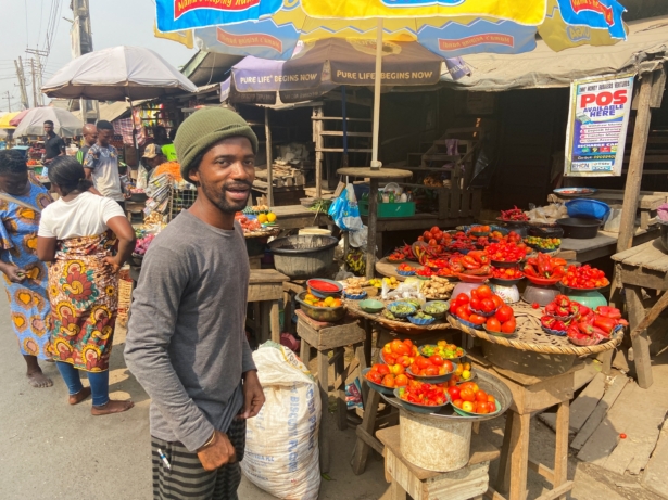 Nigerian artist Olufela Omokeko buys fresh pepper at a food market in Lagos