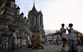 Thai Temple Bustles With Colorful Tourists