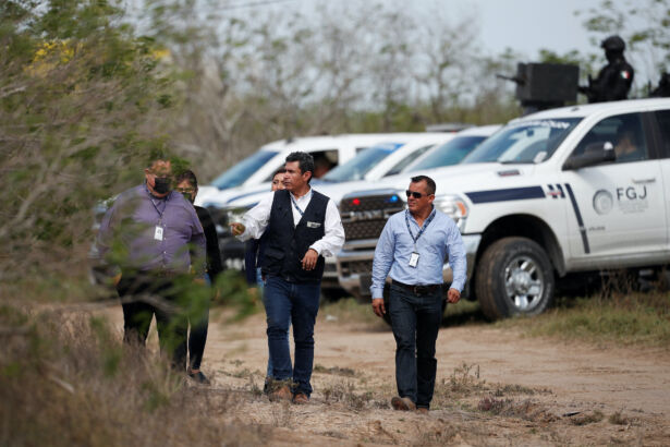 Authorities work the scene where two of four Americans kidnapped by gunmen were found dead, in Matamoros