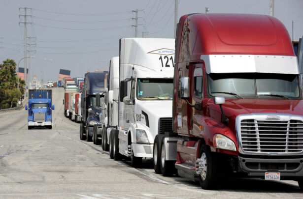 Semi-trucks line up to retrieve shipping containers from a China-based ship in Long Beach, Calif., on April 4, 2018. (Bob Riha Jr./Reuters)